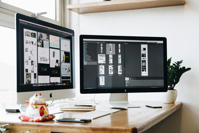 Computer monitors displaying documents